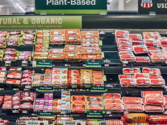 photo of retail meat case showing plant-based next to conventional meat packages