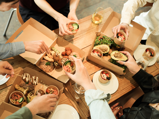 Younger adults enjoying plant-based food with plastic-free packaging.