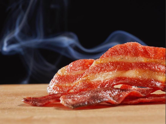 Mission Barns plant-based bacon, sitting on a counter, steaming