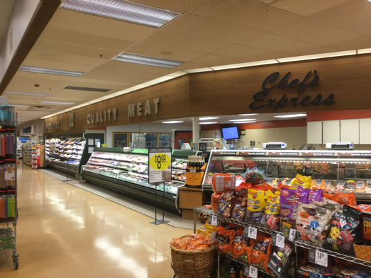 supermarket meat section with display case and refrigerated coolers
