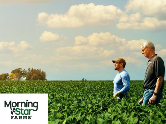 Two men walking in a field with the Morningstar Farms logo in the bottom left of the image