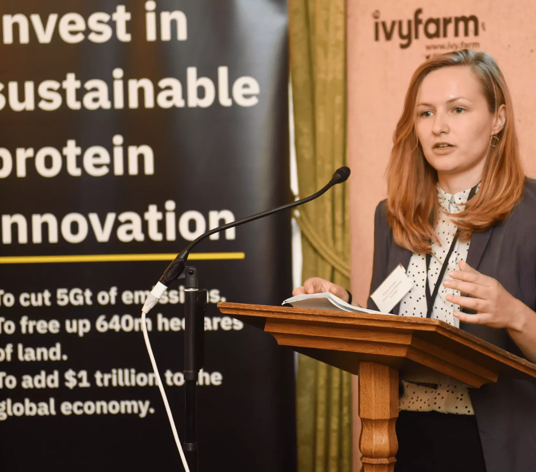 GFI Europe policy head Ellie Walden discusses investment in alt-proteins at a conference