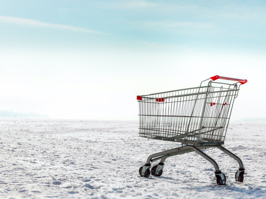 Photo of empty grocery cart in snow