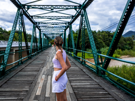 Girl looking down a bridge representing a gap in consumer perception